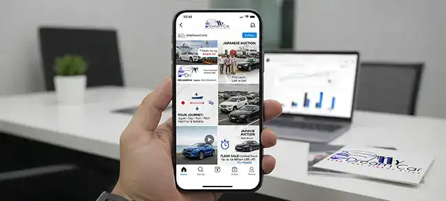 A mobile phone showing a social media feed related to car auctions and sales.